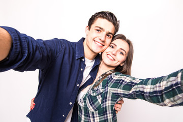 Young couple take selfie on white background