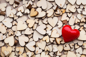 Obraz premium Wooden hearts, one red heart on the heart background.