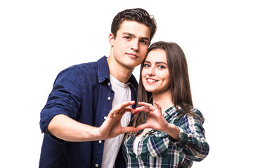 Young couple make heart symbol from their hands.