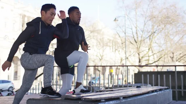 4K Two sporty men doing a workout in the city, in slow motion 