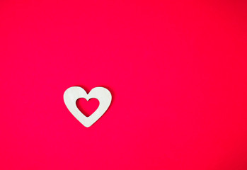 wooden heart on a pink background
