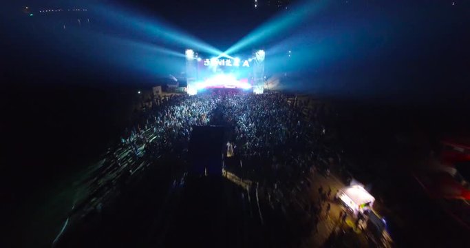 Aerial shot crowd of people dancing on a music festival