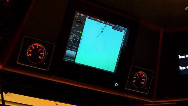 Instrument panel of ship in twilight, in lamplight. Close-up.