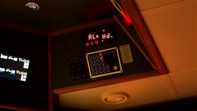 Instrument panel of ship in twilight, in lamplight. Close-up.