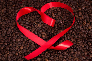 Ribbon heart shape on the coffee background