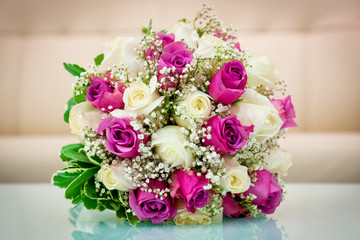 Wedding flower bouquet for the bride in white and purple roses