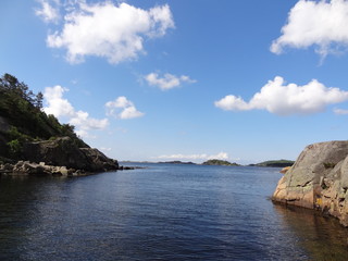 Fototapeta na wymiar Bay with blue sky and clouds near Mandal and Sjosanden beach in Norway