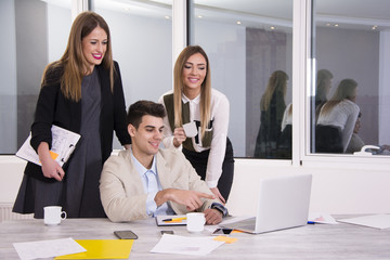Young business man and his colleagues working together. Beautiful business woman working.