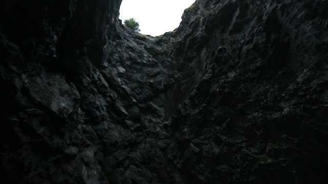 Look at the sky through the hole in the cave