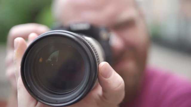 photographer frames the camera with a big lens of the camera