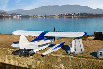 Radio controlled model seaplane. Float plane on the shore of a lake ready to fly 