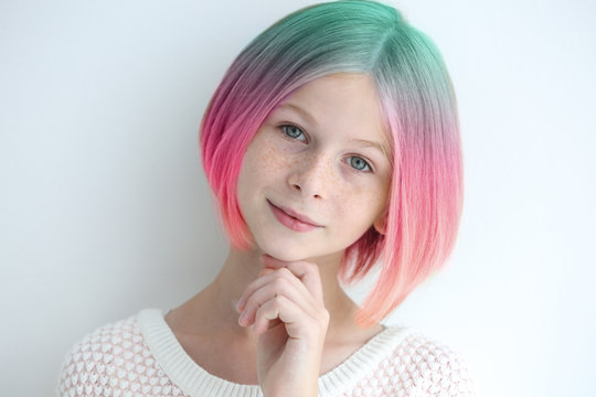 Trendy hairstyle concept. Girl with colorful dyed hair on white background