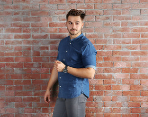 Handsome man on brick wall background