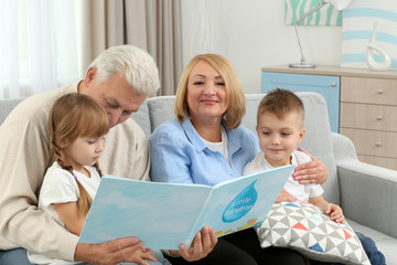 Happy family reading book on couch