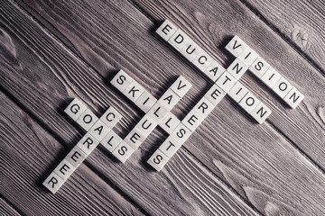 Fototapeta premium Conceptual keywords on wooden table with elements of game making crossword