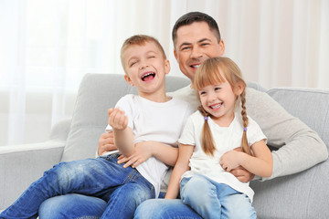Happy father with children on couch