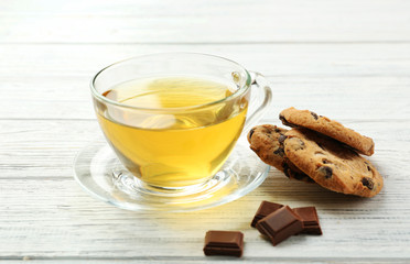 Chocolate cookies with green tea on white table