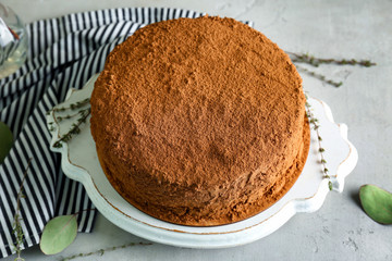 Tasty chocolate cake on wooden tray