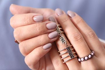 Close up view of female hands with beautiful manicure on blurred color background - obrazy, fototapety, plakaty