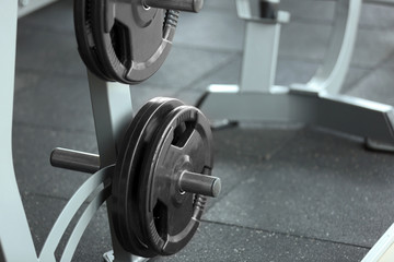 Rack with weight plates in gym, close up view