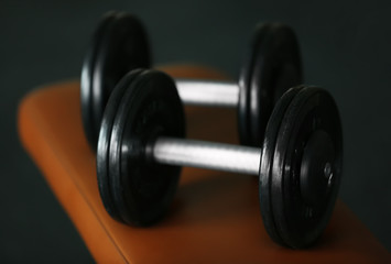 Naklejka na ściany i meble Dumbbells in gym on blurred background, close up