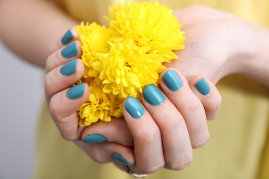 Female Hands With Beautiful Nail Art Holding Flower, Closeup