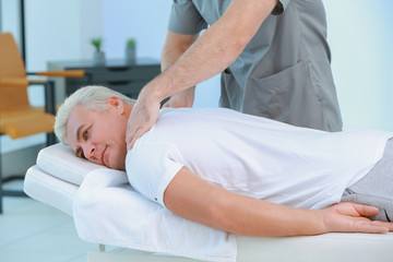 Physiotherapist working with patient in clinic