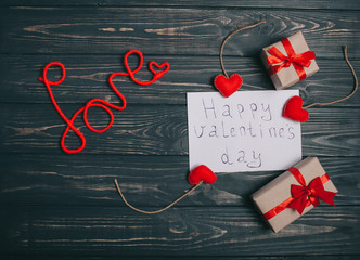 decorations for Valentine's Day. gifts, heart pillow, the word "love" and letter on wooden background