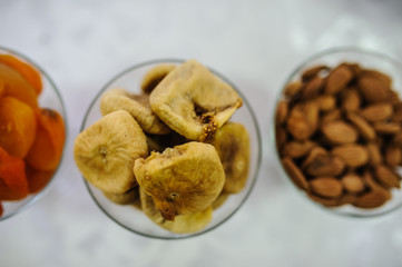 Figs, apricots, almonds in glass plate