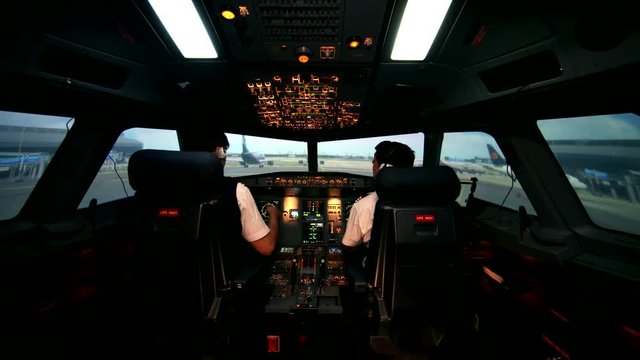 Preparing for departure and take off. Aero plane on runway of modern airport. Cabin crew perform pre-flight procedure, all lights and lamps are on