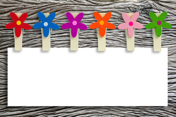 Blank white paper for text or brenner with colorful wooden clips