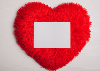 Decorations for Valentine's Day. heart pillow and letter on wooden background