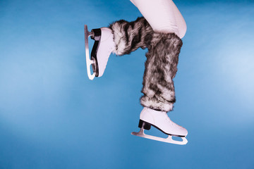 Woman legs wearing ice skates fur socks, skating