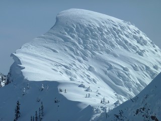 Massive cornice on the head wall above Fernie Alpine Resort looks like a frozen wave. © mat_millard