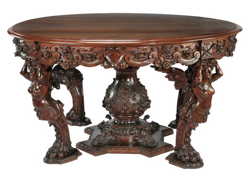 Round wood table with ornate carvings on white