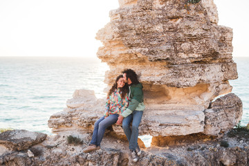 Guy and girl relaxing on the seaside with amazing view together.