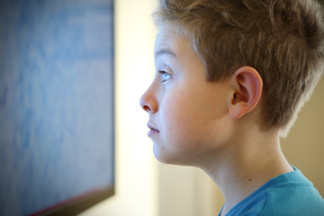 Boy watching television with noise