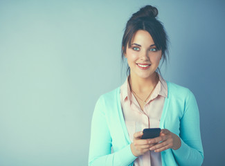 Woman using and reading a smart phone