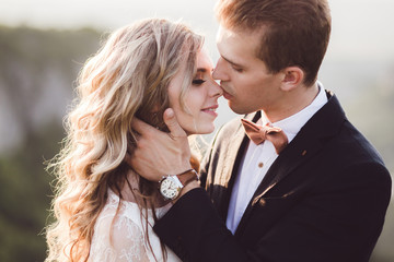 Bride and groom pretty portrait outdoors in the mountains