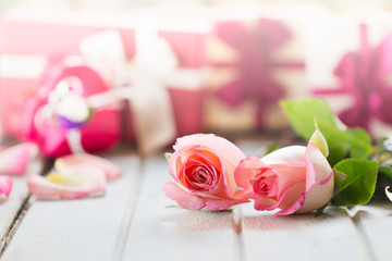Valentines day background with pink roses over wooden table