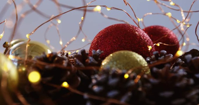 Christmas bauble and pine cone arranged with christmas lights