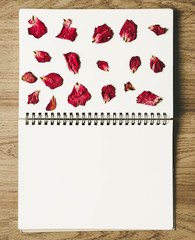 Blinder blank notebook with rose press rose flower petals, on wood backgrounds