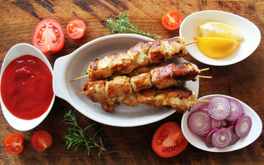 Grilled chicken kabob with ingredients and herbs. Top view.