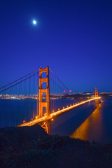 Fototapeta na wymiar Moon Rising over the Golden Gate Bridge, San Francisco at night, USA
