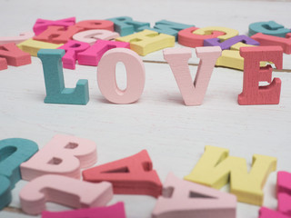 Vanlentine's day concept. Wooden letters word love and red heart  and car vintage on color background with copy space.