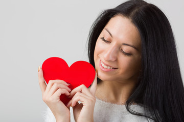 Woman holding heart in hands