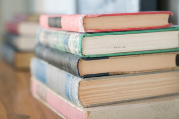 Stack of Classic Books on Bookshelf