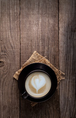 cup of cappuccino coffee on old vintage wooden table