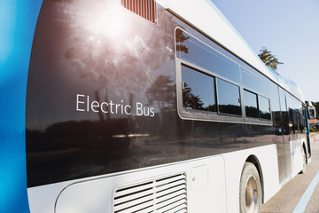 Electric vehicle bus stands at the charger. Alternative sources of fuel.