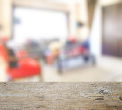 wooden table top with blur of modern interior living space